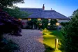 Dornywell Cottage Exterior At Night 1